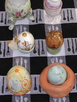 ceramic eggs in egg cups on table